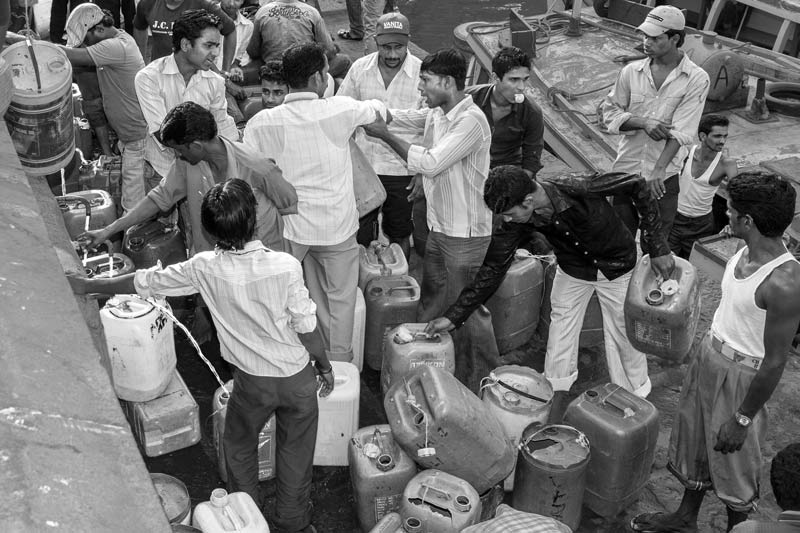 Human Right to Water in Mumbai - Boatmen quarrelling for their turn at a public tap at Gateway of India